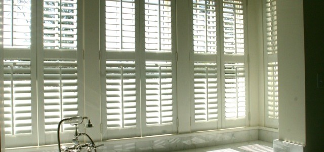 Hunter Douglas Newstyle Fauxwood shutters. Beautiful look with light and privacy control.